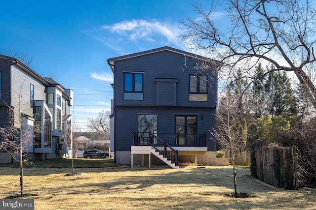 rear view of house featuring a yard