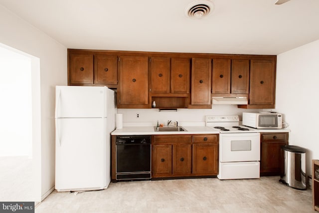 3 New Hampshire Ln Unit A, Whiting, NJ 08759 - kitchen featuring white appliances, under cabinet range hood, a sink, and brown cabinetry