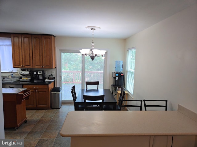 kitchen featuring pendant lighting, a kitchen island, and a chandelier