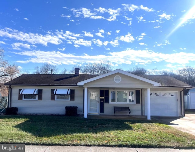 single story home with a garage and a front lawn