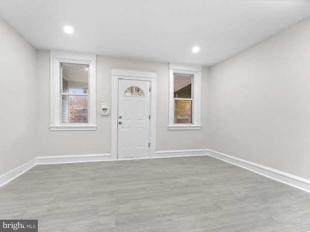 entryway with light hardwood / wood-style floors and plenty of natural light