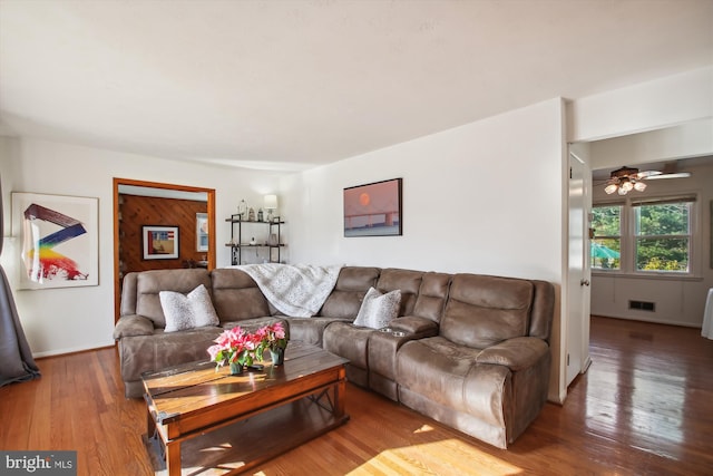 living room featuring ceiling fan and hardwood / wood-style flooring