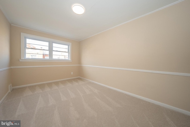 spare room featuring light colored carpet, vaulted ceiling, and ornamental molding