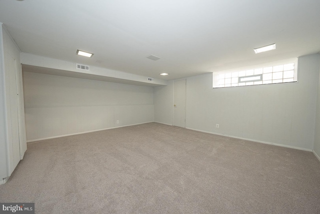 basement featuring light carpet