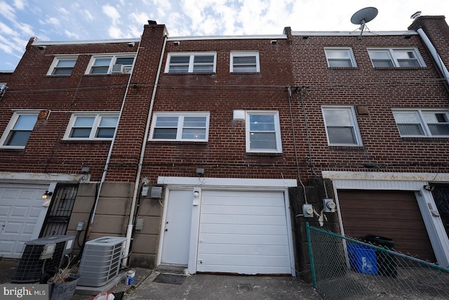 rear view of property with central AC