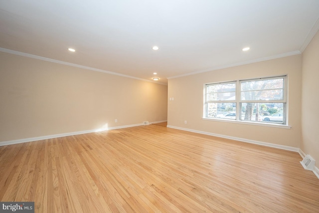 unfurnished room with light wood-type flooring and ornamental molding