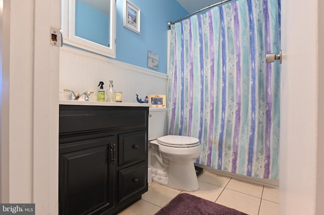 bathroom featuring tile patterned flooring, vanity, and toilet