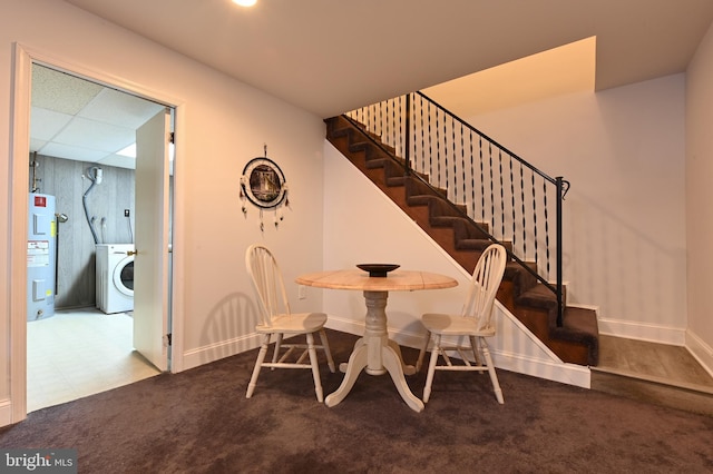 dining space with carpet, washer / dryer, and water heater