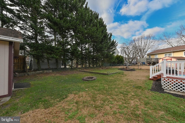 view of yard featuring a fire pit and a deck