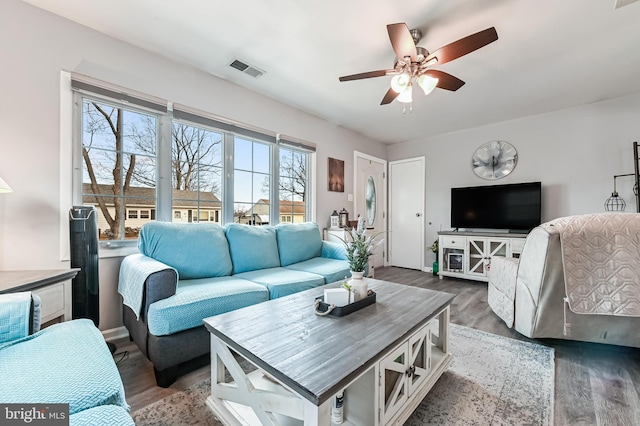 living room with dark hardwood / wood-style floors and ceiling fan