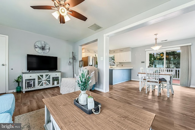 living room featuring dark hardwood / wood-style floors and ceiling fan