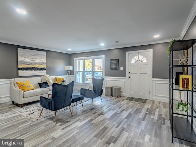 living room featuring light hardwood / wood-style floors and ornamental molding