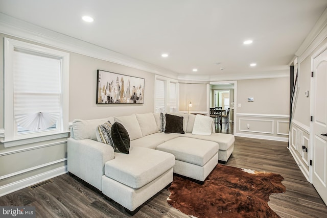 living room with ornamental molding and dark wood-type flooring