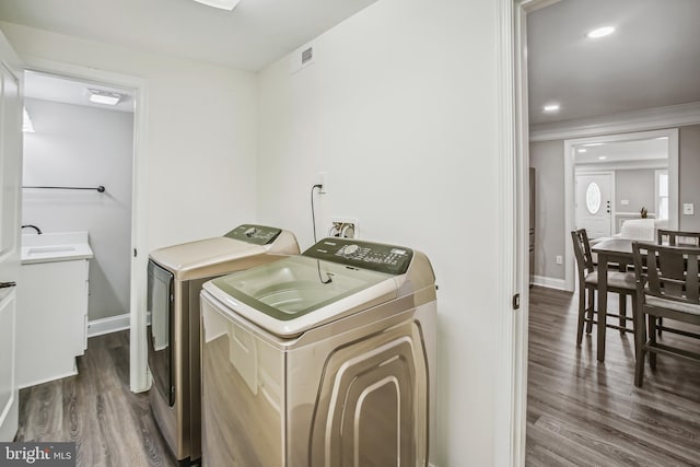 laundry room with washing machine and dryer and hardwood / wood-style floors