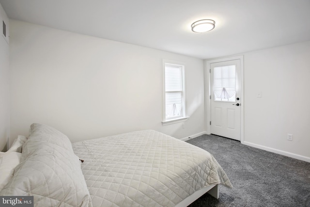 bedroom with dark colored carpet