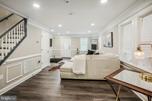 living room with dark hardwood / wood-style floors and crown molding