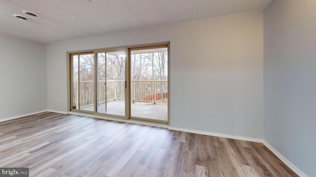 unfurnished room with light wood-type flooring