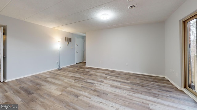 spare room with light hardwood / wood-style floors