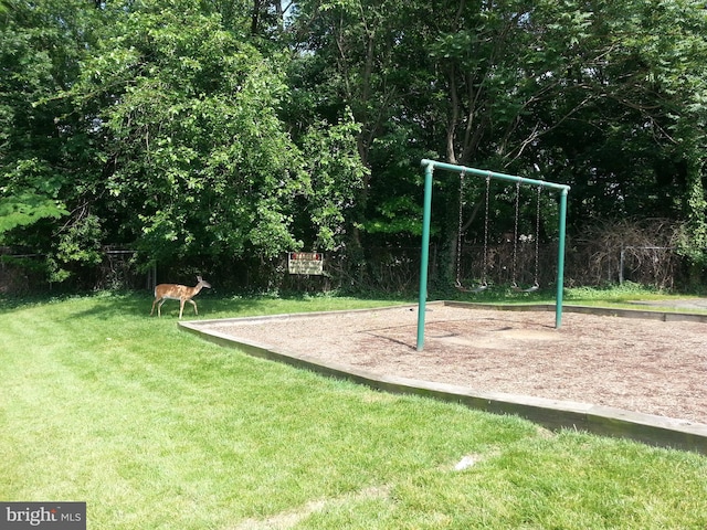 view of jungle gym featuring a lawn