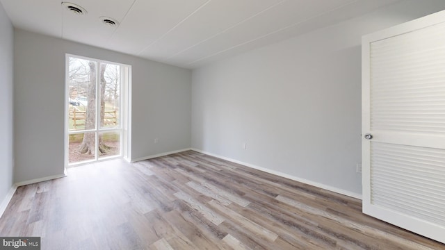 unfurnished room featuring light hardwood / wood-style floors