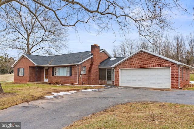 single story home with a garage and a front lawn