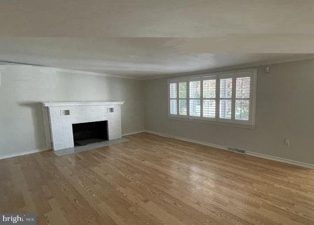 unfurnished living room with wood-type flooring