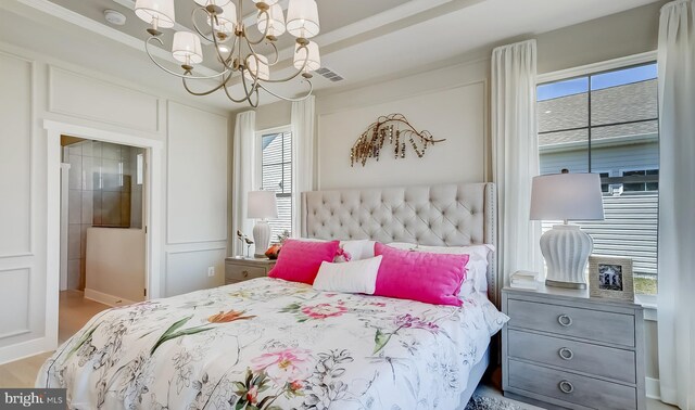 bedroom featuring an inviting chandelier and multiple windows