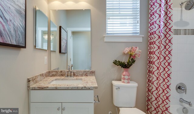 full bathroom featuring shower / bath combination with curtain, vanity, and toilet