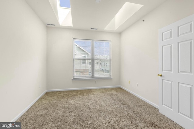 carpeted spare room with a skylight