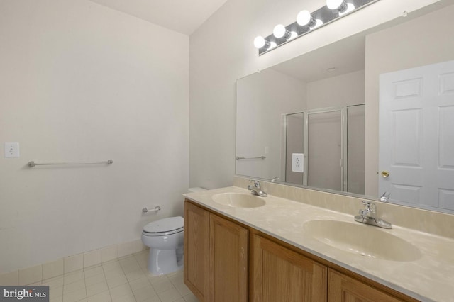 bathroom with tile patterned floors, vanity, toilet, and walk in shower