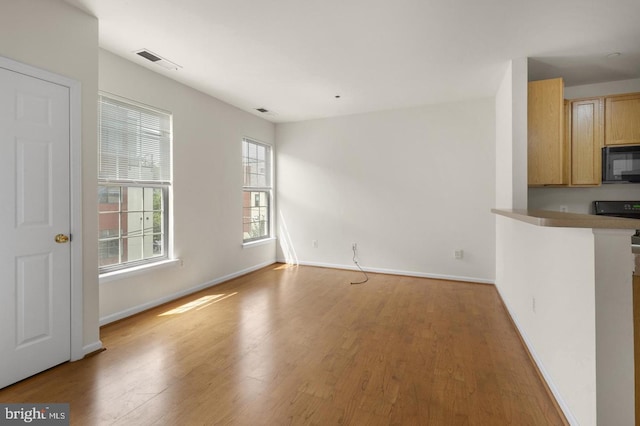 unfurnished living room with light hardwood / wood-style floors