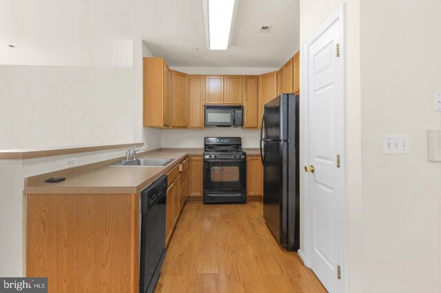 3121 W Thompson St, Philadelphia, PA 19121 - kitchen with black appliances, a sink, light wood-type flooring, and light countertops