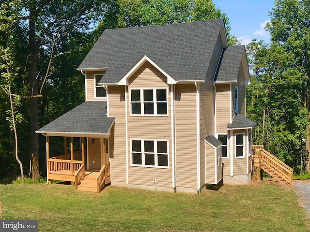 view of front of house featuring covered porch and a front lawn