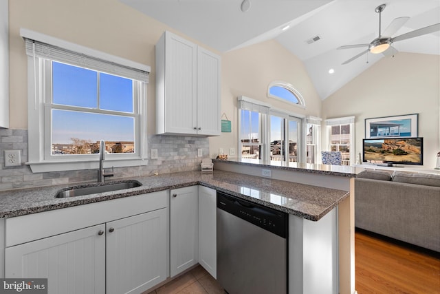 kitchen with dishwasher, white cabinets, sink, ceiling fan, and decorative backsplash