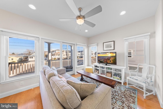 living room with ceiling fan and light wood-type flooring