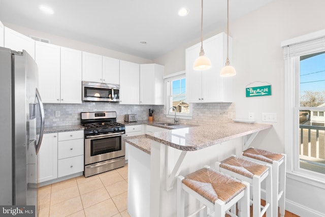 220 Taylor Ave, Beach Haven, NJ 08008 - kitchen featuring stainless steel appliances, a sink, decorative backsplash, a peninsula, and recessed lighting