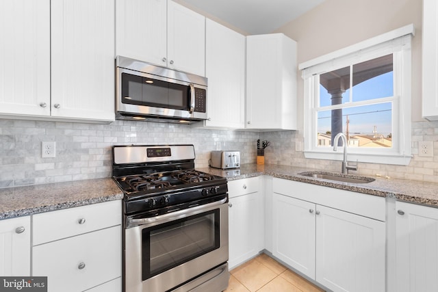 220 Taylor Ave, Beach Haven, NJ 08008 - kitchen featuring appliances with stainless steel finishes, a sink, white cabinets, and light stone counters
