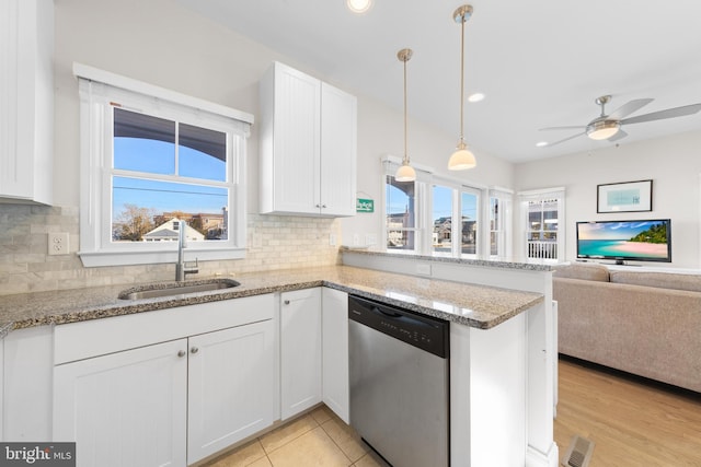 kitchen with white cabinets, dishwasher, a healthy amount of sunlight, and sink