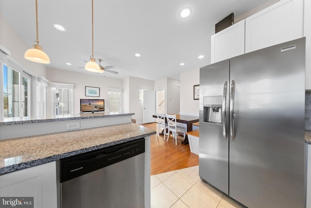 kitchen featuring light stone counters, stainless steel appliances, ceiling fan, white cabinetry, and light tile patterned flooring