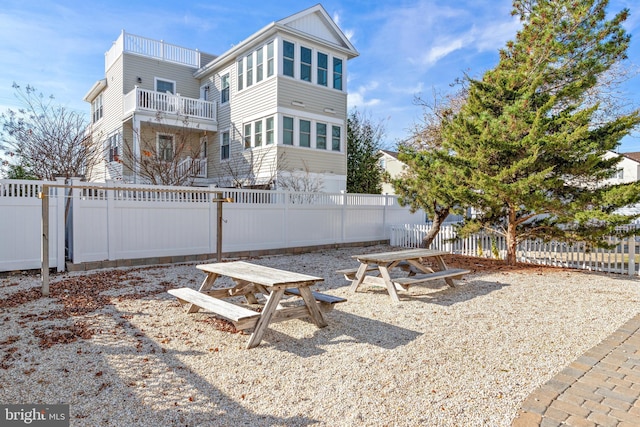 rear view of property featuring a balcony