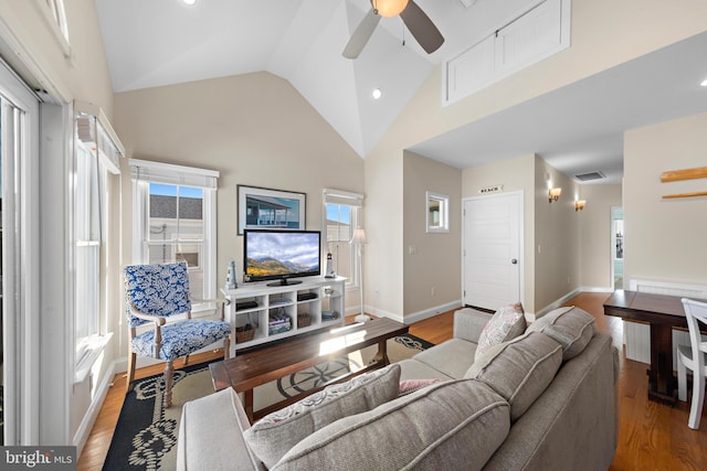 living room with wood-type flooring, high vaulted ceiling, and ceiling fan