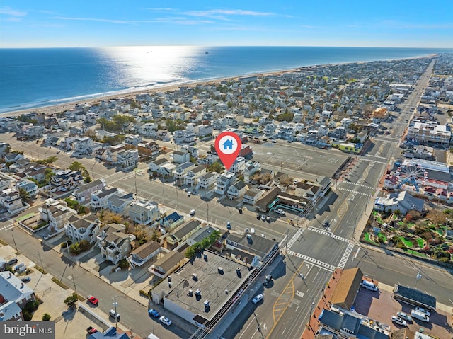 birds eye view of property featuring a water view and a view of the beach