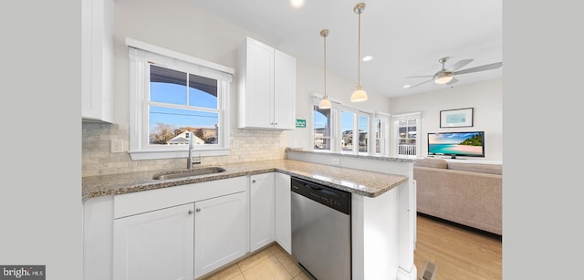 220 Taylor Ave, Beach Haven, NJ 08008 - kitchen with stainless steel dishwasher, a sink, open floor plan, white cabinets, and tasteful backsplash