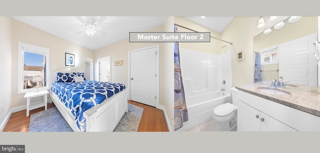 bedroom featuring ceiling fan, light wood-type flooring, and sink