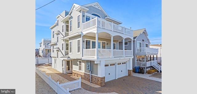 multi unit property featuring a balcony and a garage