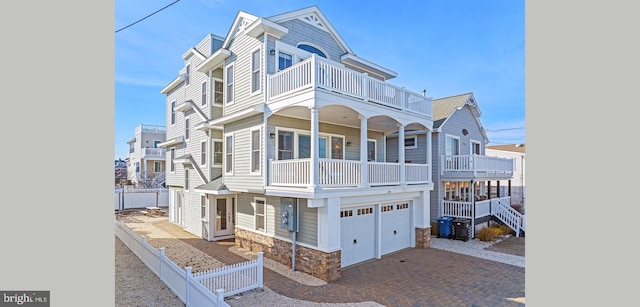 220 Taylor Ave, Beach Haven, NJ 08008 - townhome / multi-family property with a balcony, stone siding, decorative driveway, and an attached garage