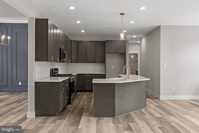 4540 Lake Rd, Newfield, NJ 08344 - kitchen featuring stainless steel appliances, a sink, light countertops, light wood-style flooring, and backsplash