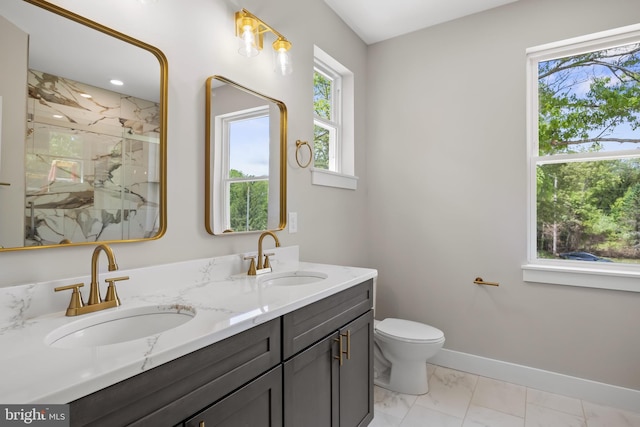 4540 Lake Rd, Newfield, NJ 08344 - bathroom with a marble finish shower, marble look tile flooring, double vanity, toilet, and baseboards