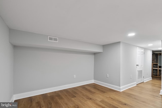 basement with light hardwood / wood-style floors