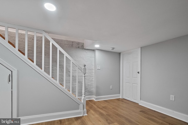 stairway with hardwood / wood-style floors